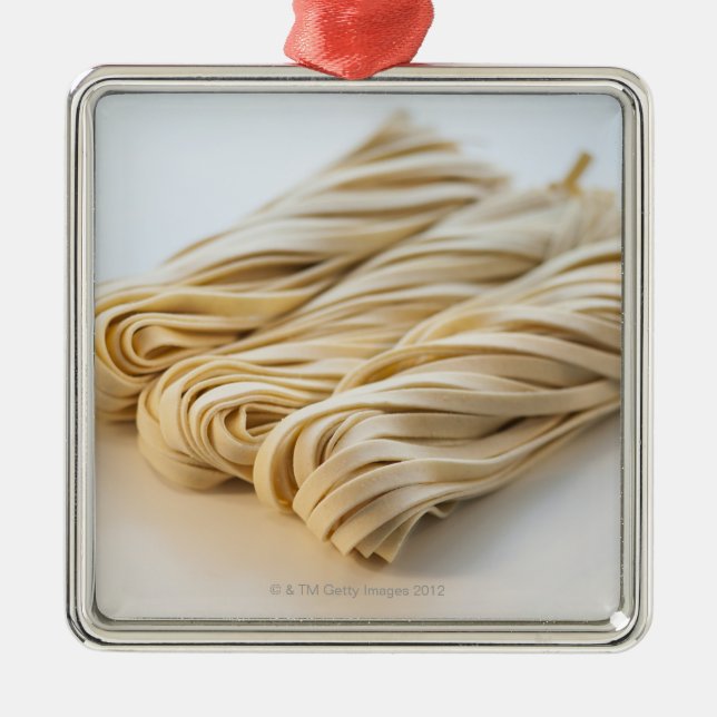 Studio shot of fresh linguini pasta metal tree decoration (Front)