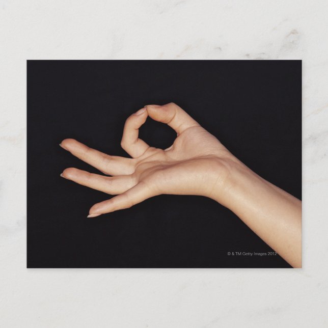 Studio shot of hand gesturing a sign postcard (Front)