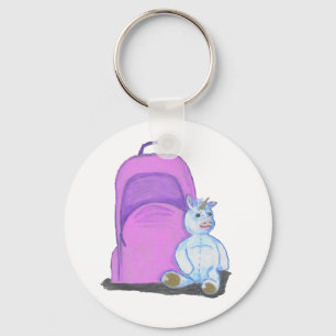 Stuffed Unicorn sits by a purple school Backpack Key Ring
