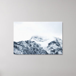 Stunning snowy mountains covered by clouds canvas print