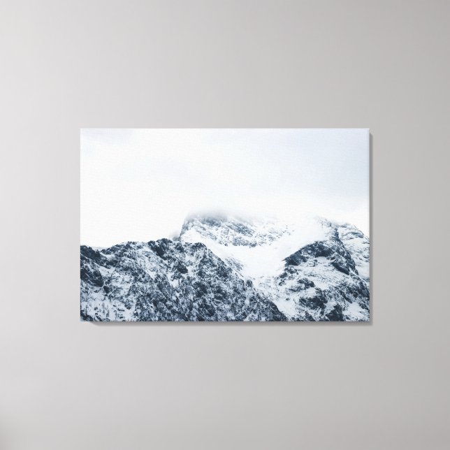 Stunning snowy mountains covered by clouds canvas print (Front)