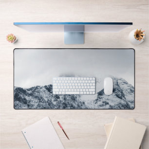 Stunning snowy mountains covered by clouds desk mat