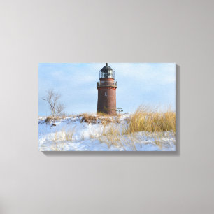 Sturdy Lighthouse on a Rocky Coast in Winter Canvas Print