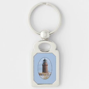 Sturdy Lighthouse on a Rocky Coast in Winter Key Ring