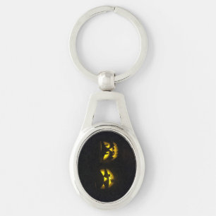 Stylish pumpkin face in eerie yellow glow oval key ring