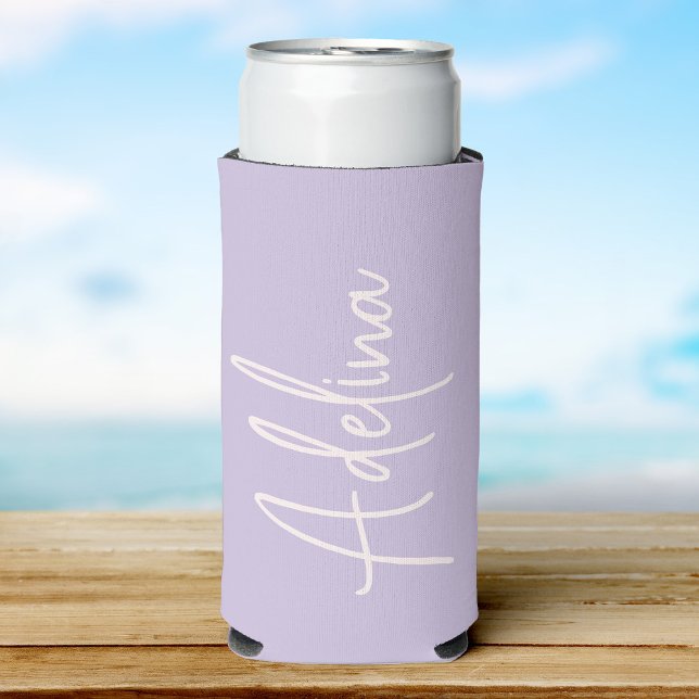 Stylish Script Custom Name Girls Beach Trip Seltzer Can Cooler (A lilac can cooler with a custom name  in elegant white script, set against a soft beach background)