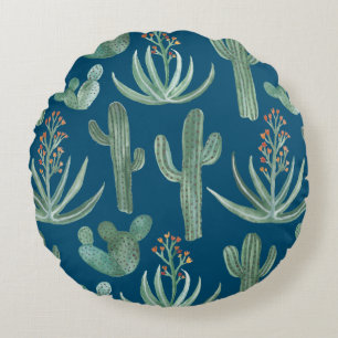 Succulents and saguaro cacti plants on blue round cushion