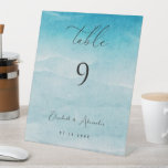 Summer Blue Ocean Beach Wedding Table Number Sign<br><div class="desc">Set the scene for a serene seaside celebration with the “Summer Blue Ocean Beach” Wedding Table Number Sign. This beautiful sign captures the essence of a beach wedding with its tranquil blue hues and ocean-inspired design. Each table number is adorned with a gentle wave pattern, evoking the peaceful rhythm of...</div>