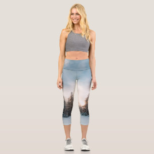Sun behind spruce trees capri leggings
