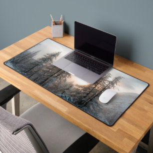 Sun behind spruce trees desk mat