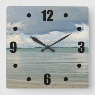SUN BREAKING THROUGH DARK CLOUDS AT BEACH SQUARE WALL CLOCK