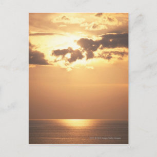 Sun goes down on the ocean postcard