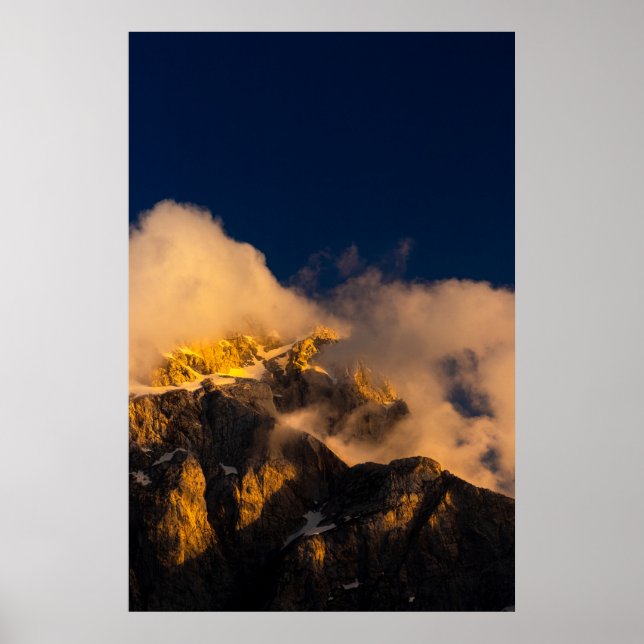 Sun lit mountains covered by clouds poster (Front)