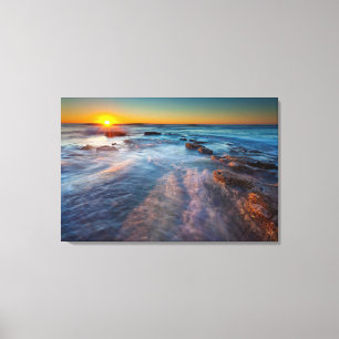 Sun rays illuminate the Pacific Ocean Canvas Print