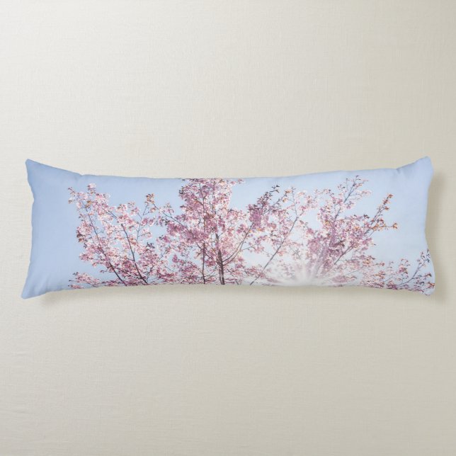 sun rays pass through pink flowers of a wow tree body cushion (Front)