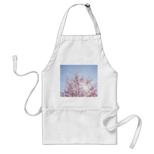 sun rays pass through pink flowers of a wow tree standard apron