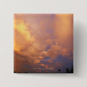 Sun setting behind clouds 15 cm square badge