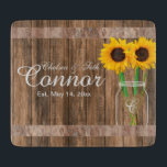 Sunflower Wedding Barn Wood Mason Jar Cutting Board<br><div class="desc">⭐⭐⭐⭐⭐ 5 Star Review. Cutting Board. Add style to the home. Featuring a barn wood look with a chalk white mason jar and sunflowers. This cutting board can be personalised with names and a date. Makes a wonderful housewarming gift, a wedding or anniversary gift. NOT ALL TEMPLATE OPTIONS NEED CHANGED...</div>