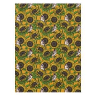 Sunflowers and goldfinches on orange tablecloth