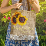 Sunflowers burlap lace wedding mother of the bride tote bag<br><div class="desc">Rustic elegant summer or autumn fall wedding stylish mother of the bride / mother of the groom / bridesmaid / maid of honour / flower girl tote bag on beige faux burlap featuring beautiful yellow gold sunflowers bouquets and white lace borders on both faces. Easy to personalise with bridesmaid's name...</div>