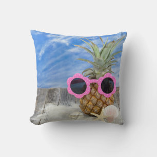 sunglasses on pineapple with seashells cushion