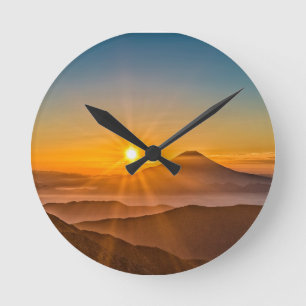 Sunrise between the hills round clock