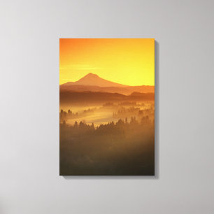 Sunrise orange colours the fog in the valley in canvas print