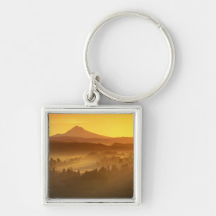 Sunrise orange colours the fog in the valley in key ring
