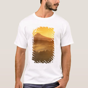 Sunrise orange colours the fog in the valley in T-Shirt