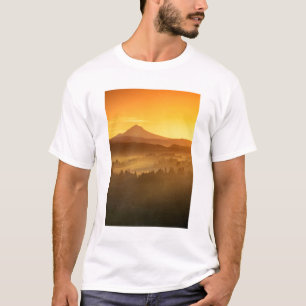 Sunrise orange colours the fog in the valley in T-Shirt