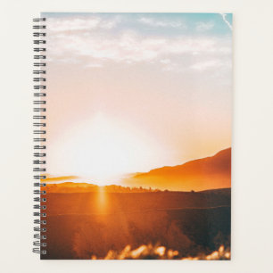 sunrise over a mountain planner