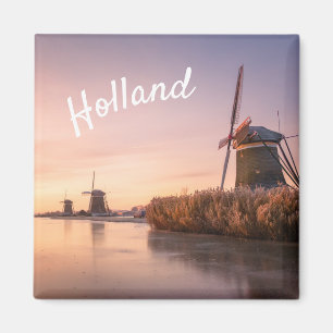 Sunrise over frozen river with windmills and reeds magnet