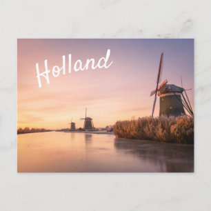 Sunrise over frozen river with windmills and reeds postcard