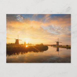 Sunrise over windmills and a river in Holland Postcard
