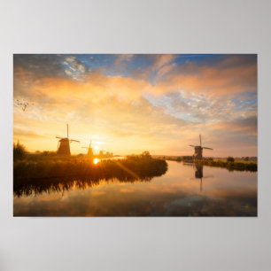 Sunrise over windmills and a river in Holland Poster