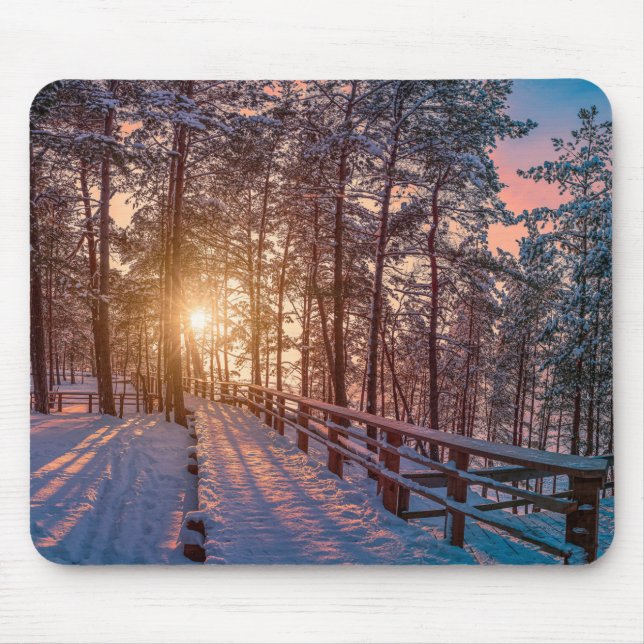 Sunset in snowy pine forest with sun ray mouse mat (Front)