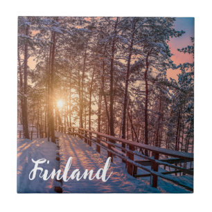 Sunset in snowy pine forest with sun ray tile