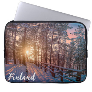 Sunset in snowy pineforest with sun ray laptop sleeve