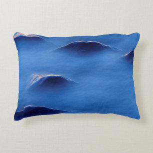 Sunset on rocks protruding through foamy water decorative cushion