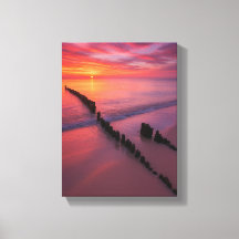 Sunset Over Beach with Wooden Posts