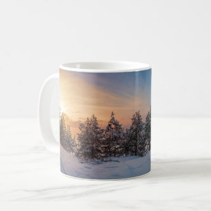 Sunset over frozen snowy forest near sea coffee mug