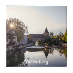 Sunset over old mediaeval bridge in Nuremberg Tile