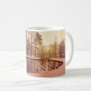 Sunset over park with small frosty lake coffee mug