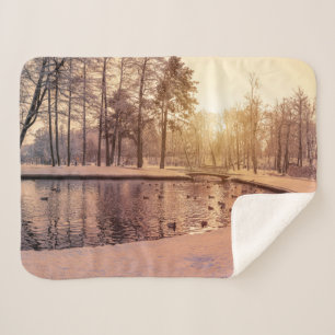 Sunset over park with small frosty lake sherpa blanket