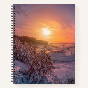 Sunset over snow sea coast notebook