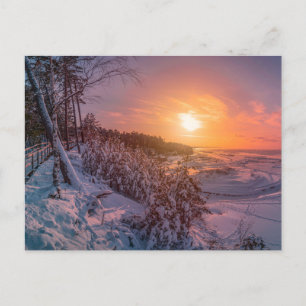 Sunset over snow sea coast postcard