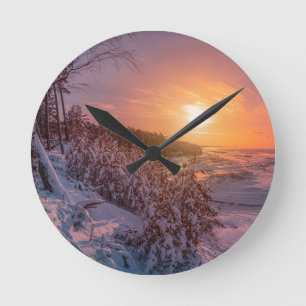 Sunset over snow sea coast round clock