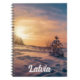 Sunset over snowy winter seacoast notebook