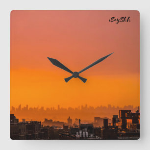 Sunset over the city square wall clock