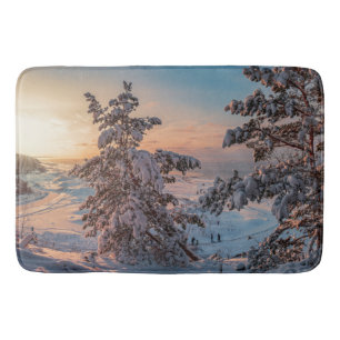 Sunset over winter snowy sea coast bath mat